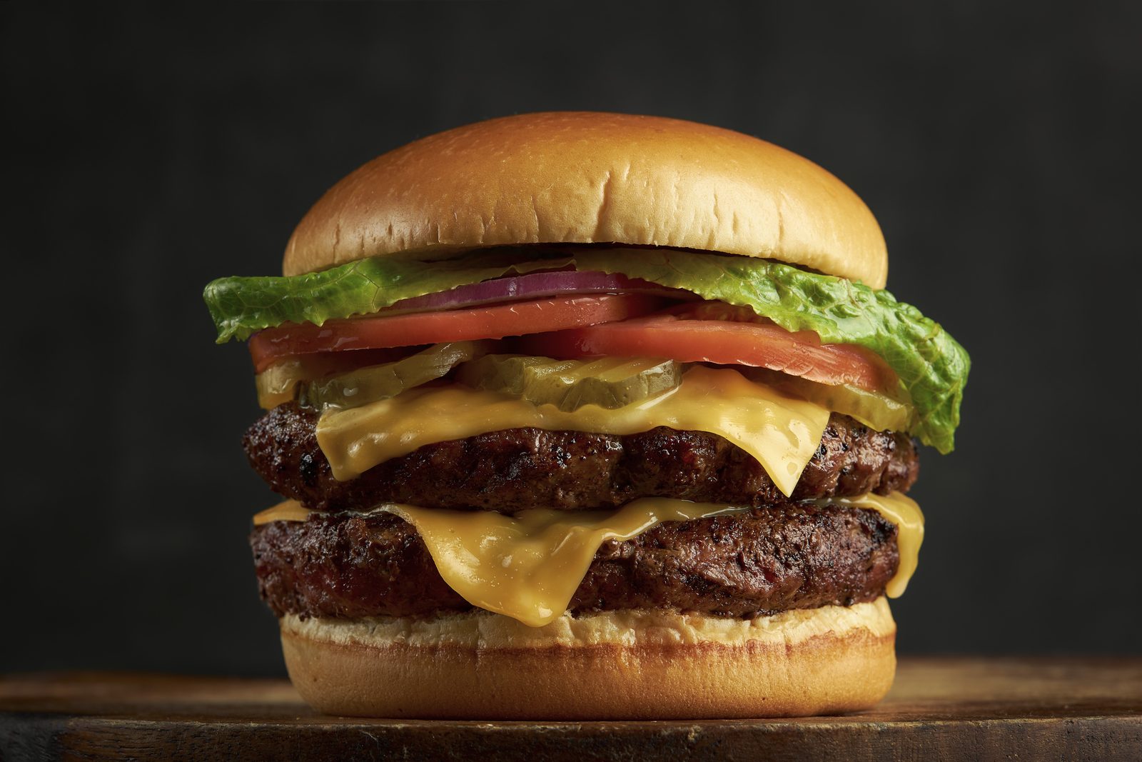 Double smashed cheeseburger with melted American cheese, lettuce and tomato